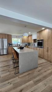 a large kitchen with a island in the middle of it at Hoʻonānea I Loko Kailua in Kailua