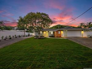 a house with a lawn in front of a house at Hoʻonānea I Loko Kailua in Kailua