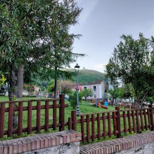 a wooden fence with a park in the background at Il giardino di Emilia in Raviscanina