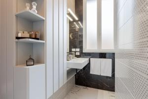 a bathroom with a sink and a mirror at The Romulus in Rome +31 photos