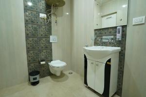 a bathroom with a sink and a toilet at Nature's Edge Nishat Srinagar in Srinagar +11 photos