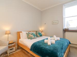a bedroom with a bed with two pillows on it at Sunrise Apartment in Weymouth