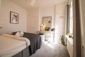 a bedroom with a bed and a desk at Seymour Place, Hyde Park, Edgware Road London Apartments in London