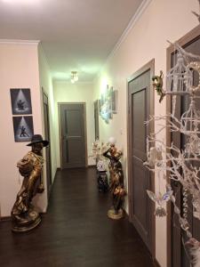 a hallway with statues of people in a room at B&B Sandra in Alūksne