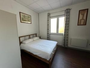 a small bedroom with a bed and a window at Domaine des Anges in Amélie-les-Bains-Palalda