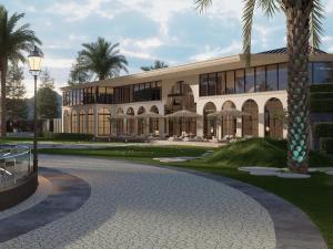 un bâtiment avec un palmier en face dans l'établissement Nawab Estate Resort and Residencia, à Lassān