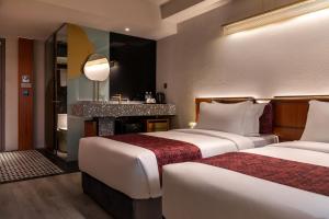 Postel nebo postele na pokoji v ubytování Bintang Collectionz Hotel