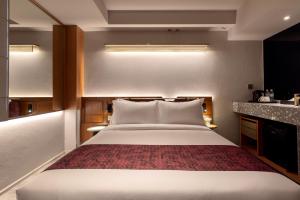 Postel nebo postele na pokoji v ubytování Bintang Collectionz Hotel