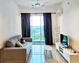 a living room with a couch and a large window at Metropol Penang in Bukit Mertajam