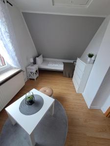 a white living room with a white table and a couch at Haus-zur-Entspannung in Albertsdorf