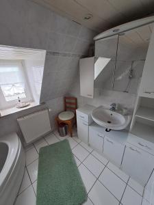 a white bathroom with a sink and a toilet at Haus-zur-Entspannung in Albertsdorf