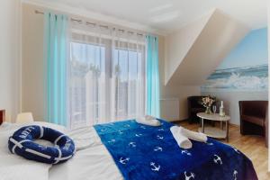 a bedroom with a bed with a large window at Villa Konwalia in Grzybowo