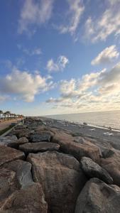 a group of people on a beach with rocks at Aqua Batumi 47 in Batumi