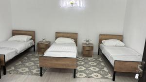 a room with two beds and two tables and a window at Hostel,halal in Tokmok +16 photos