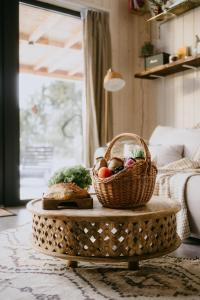 a basket of food on a table in a living room at Garczovka - domki, jacuzzi, sauna in Garcz