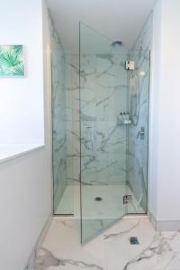 a shower with a glass door in a bathroom at Sunny townhouse Central city 2 bedroom in Christchurch