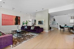 a living room with a purple couch and a table at Exclusive Penthouse with Terrace in Bergen