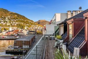 a view of a town with a river and buildings at Exclusive Penthouse with Terrace in Bergen
