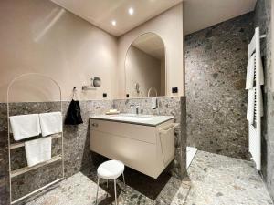 a bathroom with a sink and a mirror at Romantik Hotel Kieler Kaufmann in Kiel