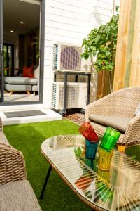 a patio with a table and chairs and a fan at Sunny townhouse Central city 2 bedroom in Christchurch