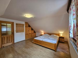 a bedroom with a large bed in a attic at Drevenice Zuberec in Zuberec