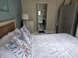 a bedroom with a bed and a bathroom with a shower at Senelle accomodation in Hermanus