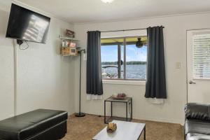a living room with a couch and a window at Fife Lake Lodge 2BR Loft with Kitchen & Lake Views in Fife Lake