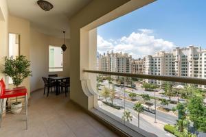 a balcony with a view of a city at Bespoke Holiday Homes - Palm Jumeirah 2 Bedroom Al Nabat Residence in Dubai