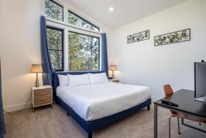 克利埃勒姆Suncadia 7 Bdrm Home with Amazing View and a Hot Tub的一间卧室，有一张床、一张书桌和两扇窗户 更多91张照片