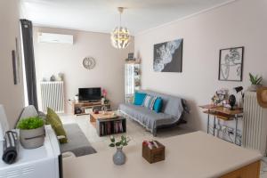 a living room with a couch and a table at Bluehouse in Porto Rafti