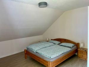 a bedroom with a bed with two pillows on it at Natur pur im schönen Sauerland in Allendorf