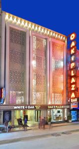 a white day shop with lights on the facade at Hotel Oak Plaza, New Delhi in New Delhi