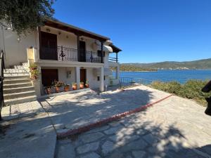 a house next to a body of water at SEA HOUSE KOUKOULEIKA in Milina