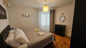 a bedroom with a bed with two towels on it at Lopar Lidija in Lopar
