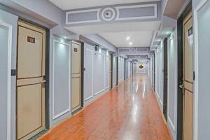an empty hallway in a building with wood floors and ceilings at Crescent Rooms And Banquet in Surat