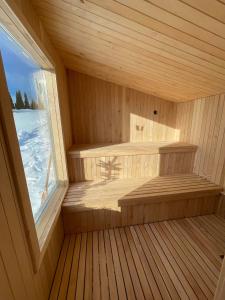 a sauna with a window in a wooden room at Dwa Słowa in Giżycko