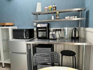 a kitchen with a counter top with a microwave at Rectory Cottage in Croydon
