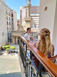 two people sitting on a balcony looking at a city at City View Palace hotel in Cairo