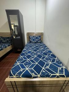 a bedroom with a bed in a room with a mirror at Metro Single beds boys room next to Union Metro Station in Dubai