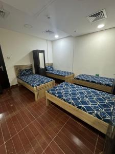 a room with three beds in a room at Metro Single beds boys room next to Union Metro Station in Dubai