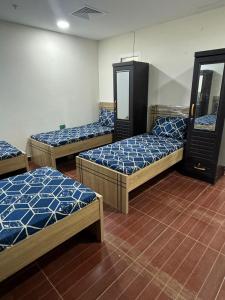 a room with three beds and a mirror at Metro Single beds boys room next to Union Metro Station in Dubai