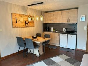 a kitchen with a wooden table and chairs at Appartement Zugspitze 2 in Ehrwald