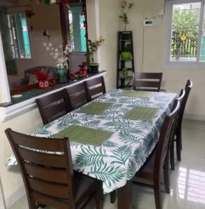 a dining room table with a blue and white table cloth at The Green House in Sorsogon
