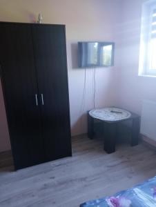 a bedroom with a black cabinet and a table at Villa pod gruszą in Połom Mały
