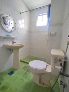 a bathroom with a toilet and a sink at The Little Star Hotel & Studio at Star Regency Residence in Brinchang