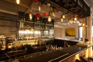 a bar in a restaurant with a counter and lights at Riverview Residence in Bangkok