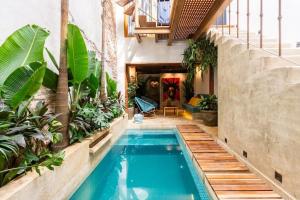 a swimming pool in a house with plants at Casa Coco 1680 Colonial & Art House In Old City - Pool - Jasussi - View in Cartagena de Indias
