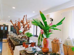 a living room with plants on a counter at Saigon-Ba Be Resort in Ba Be