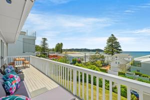 a balcony with a view of the ocean at Delightful 3-Bed Home Minutes from Avoca Beach in Avoca Beach