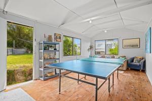 a living room with a ping pong table in it at Delightful 3-Bed Home Minutes from Avoca Beach in Avoca Beach